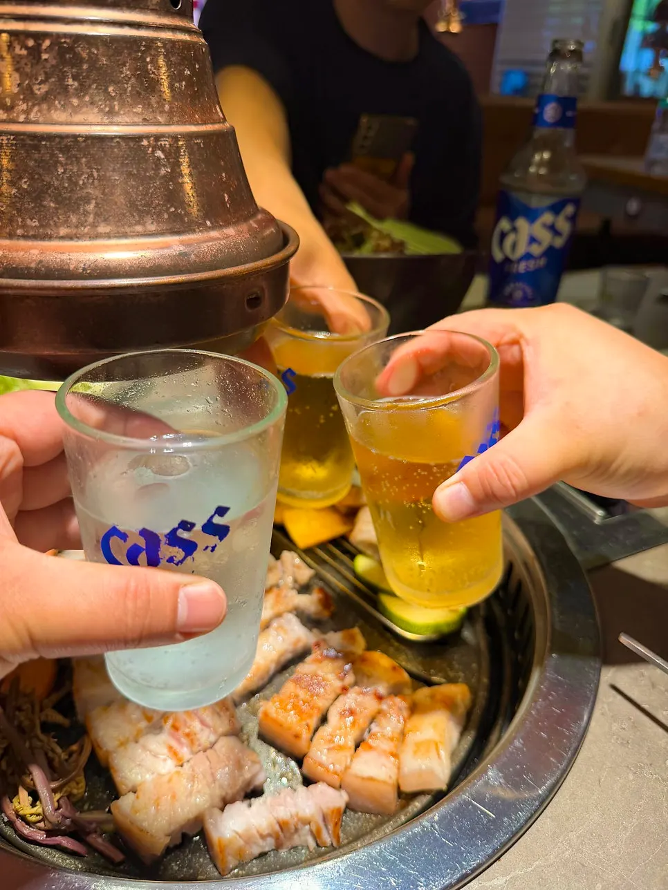 Beer, soju and cider set alongside the meat