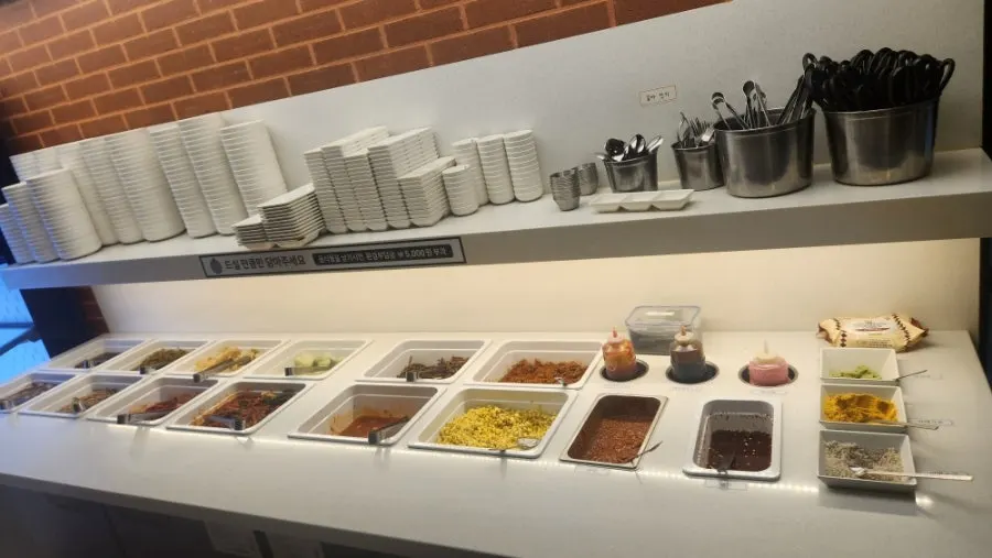 Side dishes and lettuce wraps displayed at the self-serve bar