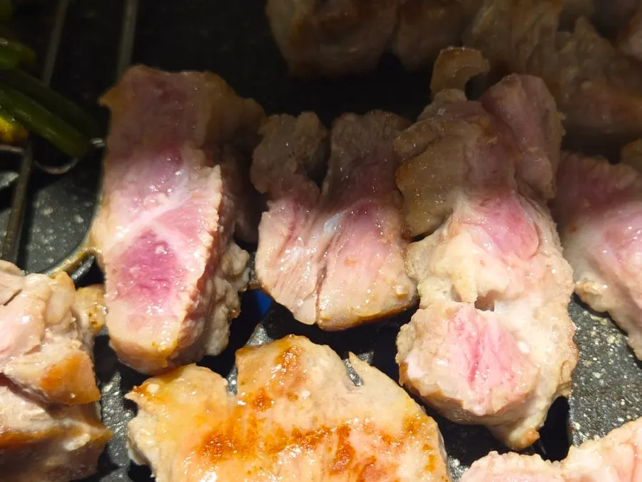 Aged meat cooking on the grill