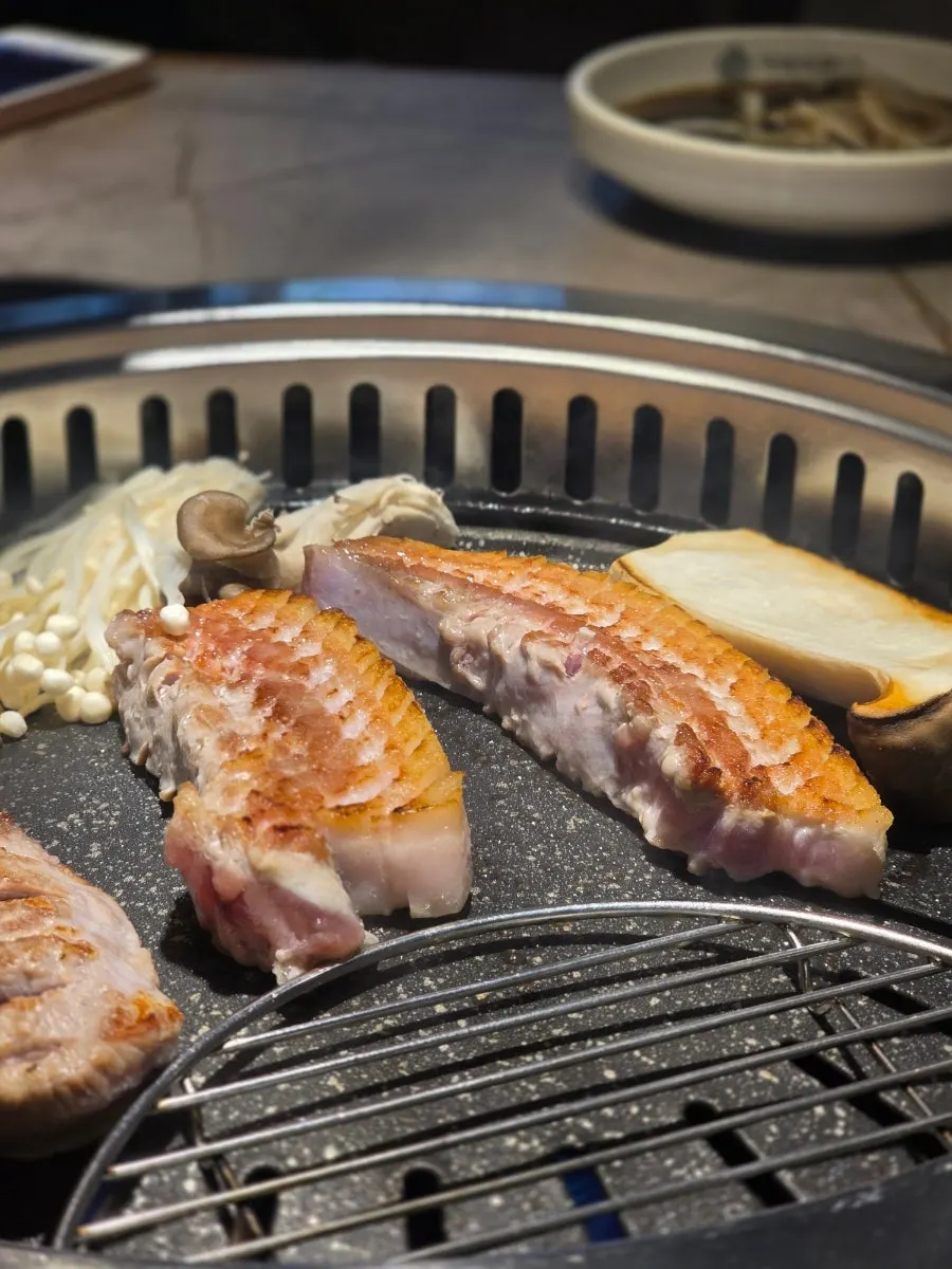 A spread of meat being grilled by the diner