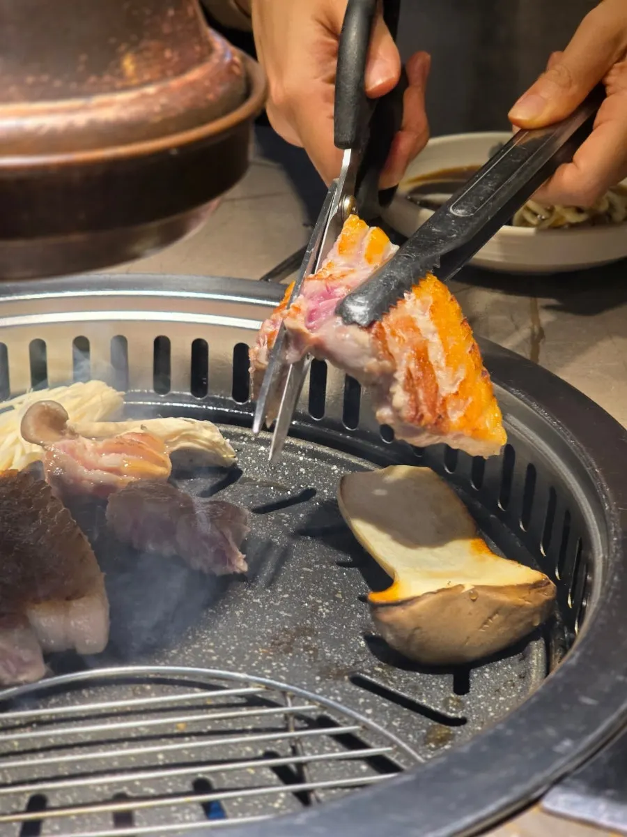The writer grilling meat