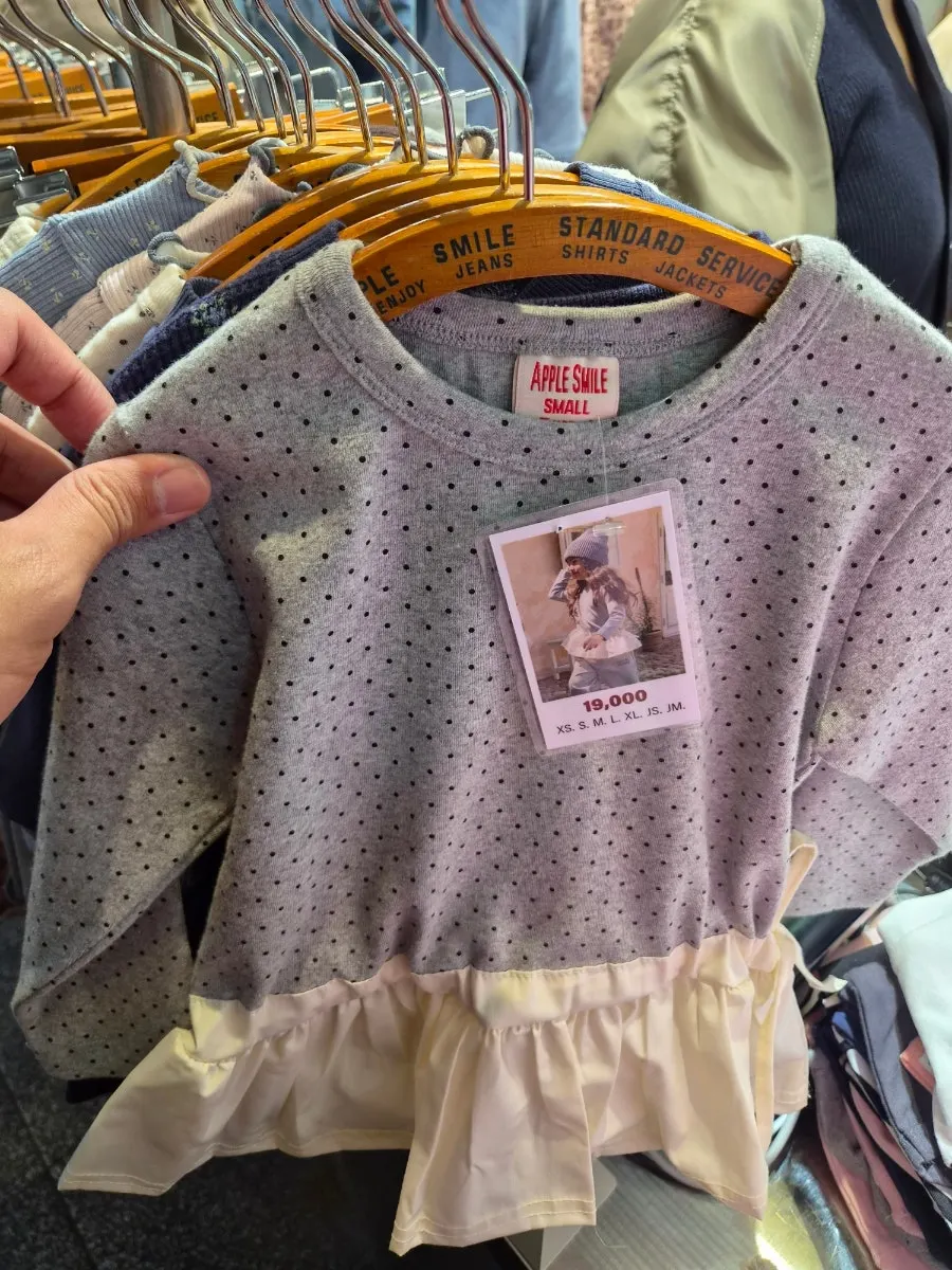 Interior of a kids' clothing shop with junior sizes on display