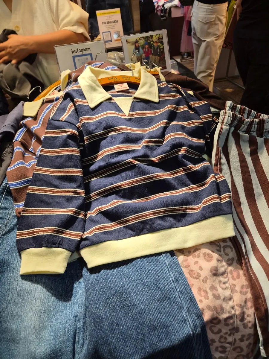 Browsing and checking clothes in person at a kids' clothing shop