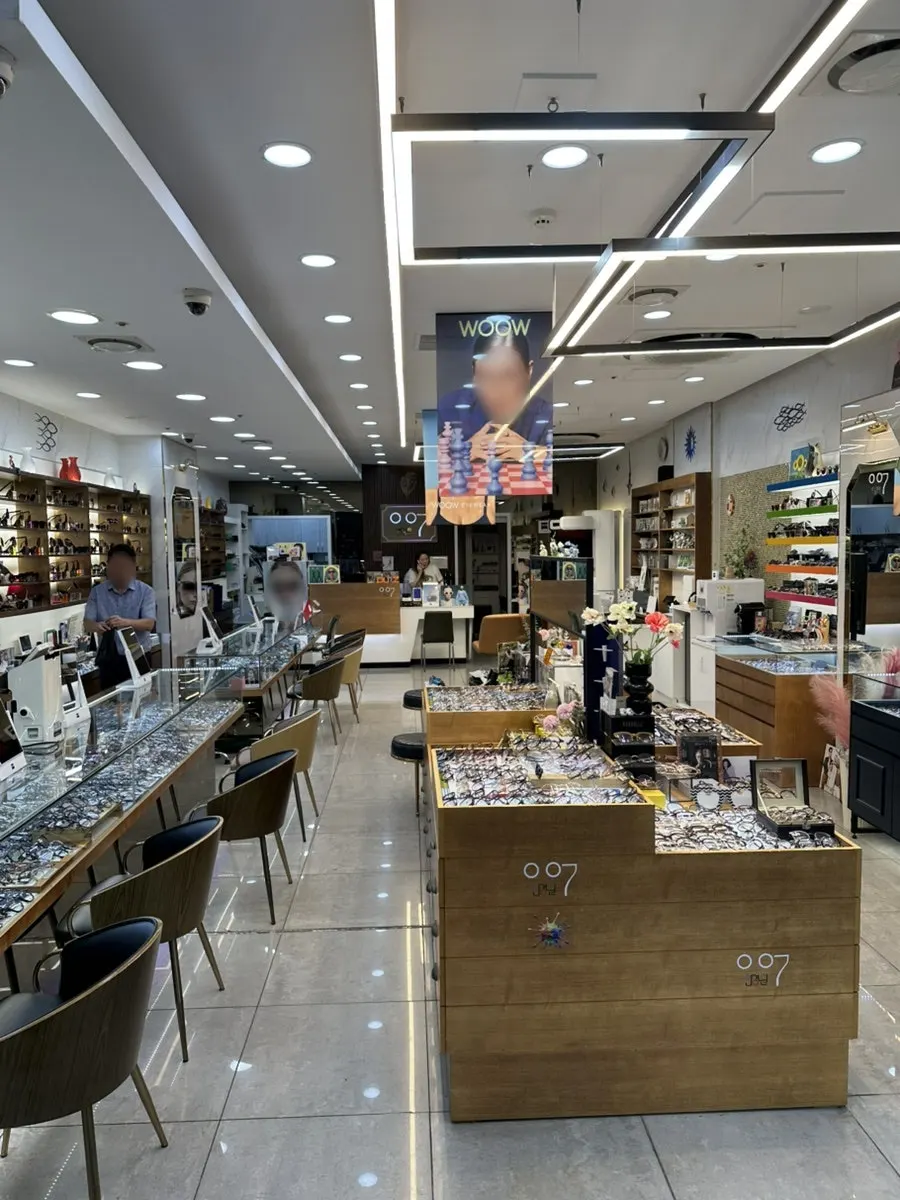 Photos of regular celebrity customers displayed inside 007 Optical