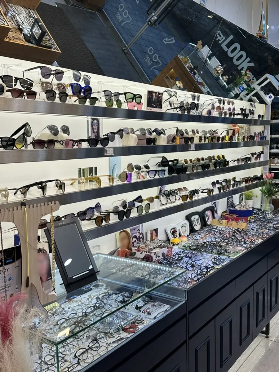 Display case with a wide variety of frames organized neatly