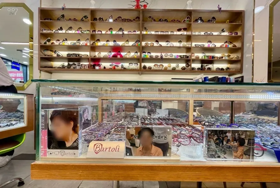 Frame display shelf with price stickers shown