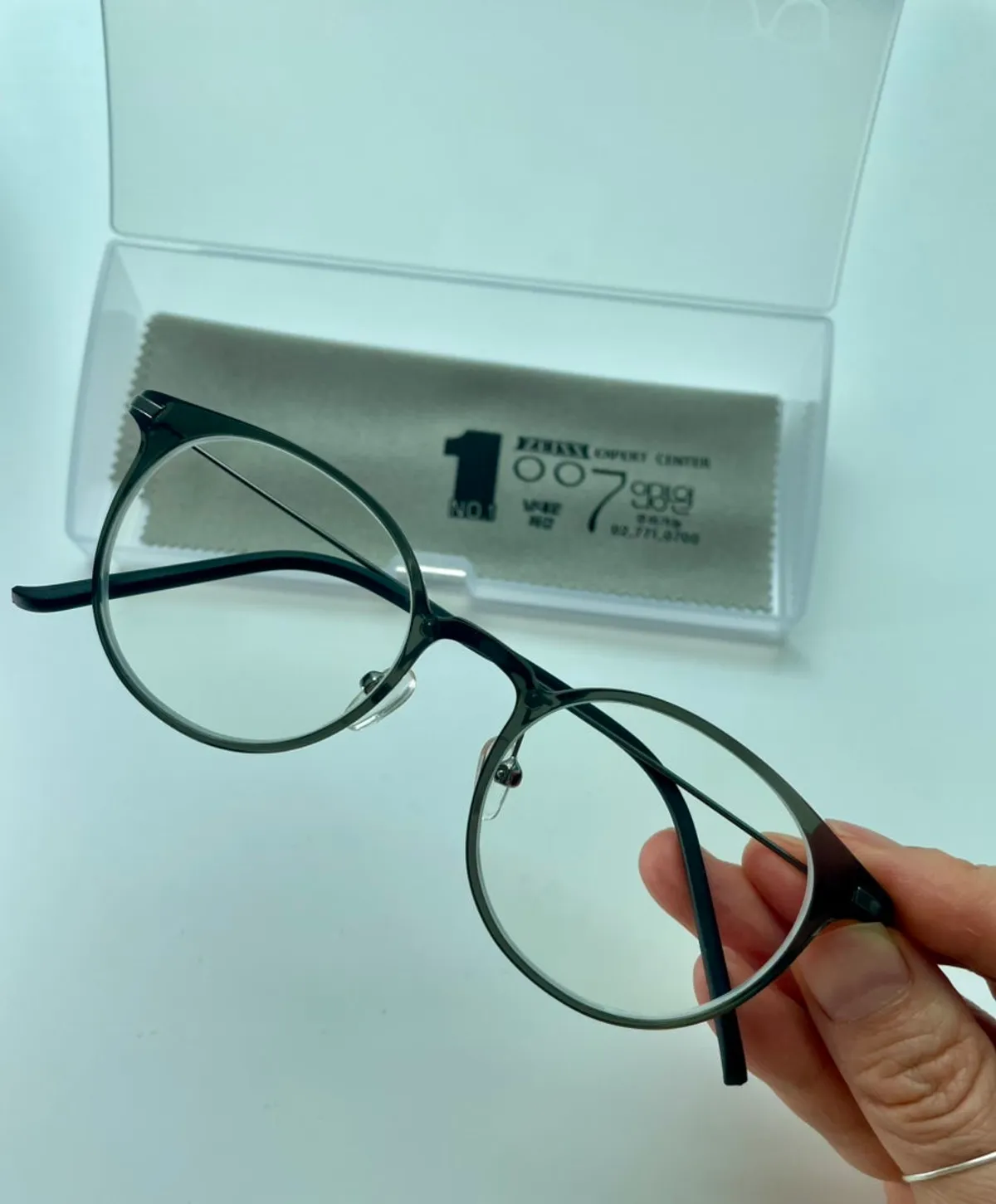 Wearing the newly made black horn-rimmed glasses