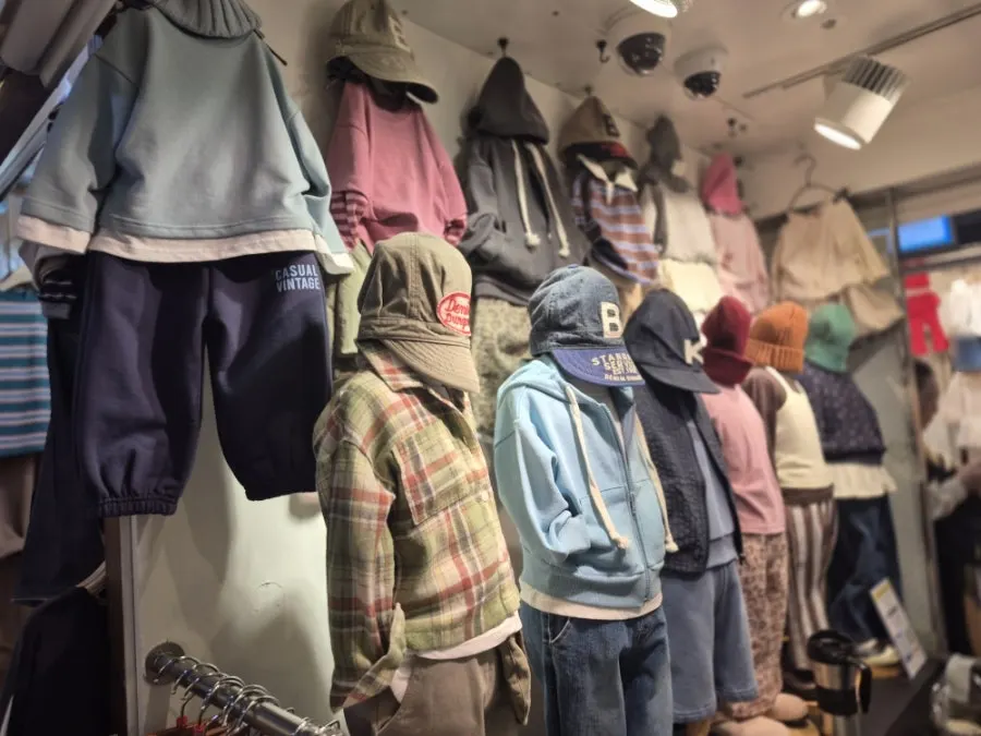 Kids' clothing section with knits and hats displayed together