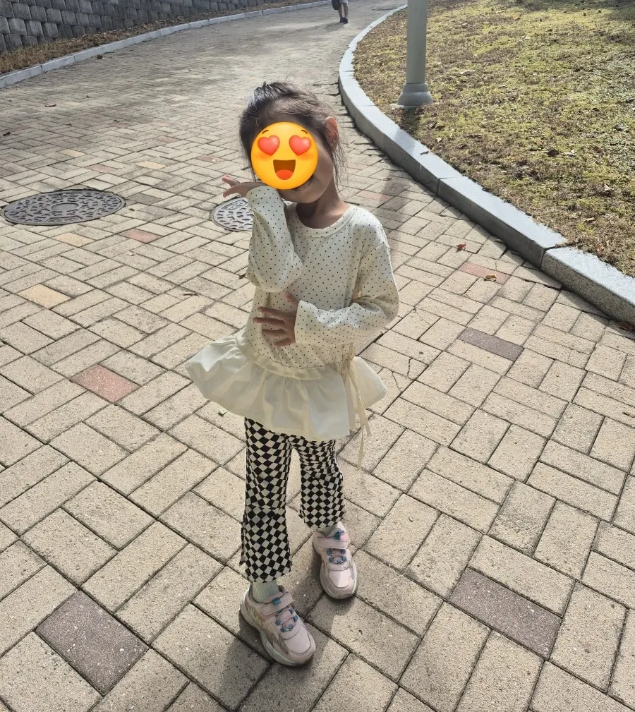 Younger child wearing the dot frill t-shirt