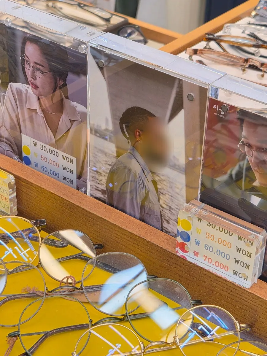 Beige clear-frame sunglasses where fingerprints are easily visible