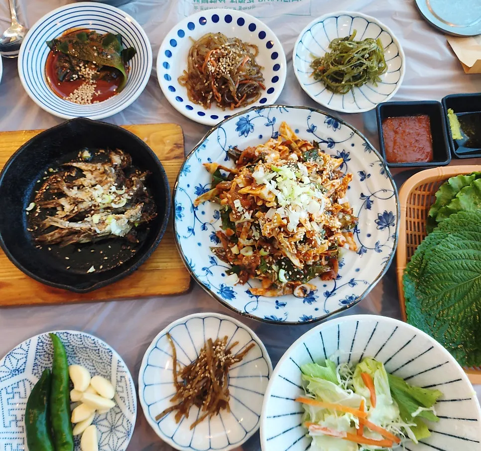 Table set with raw anchovy and side dishes