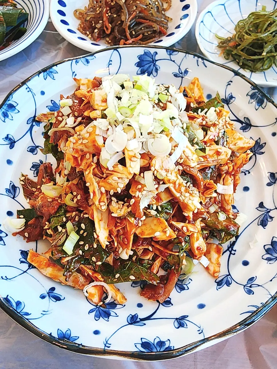 Plate of raw anchovy tossed with cabbage, perilla leaves, and green onion