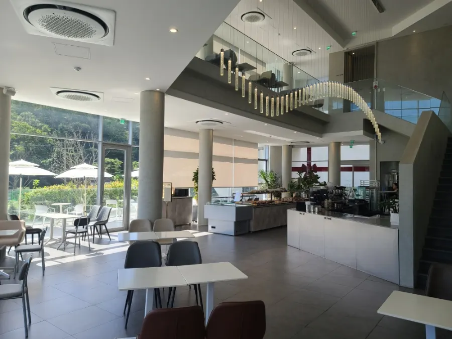 Outdoor area in front of Café Sum with mountains behind