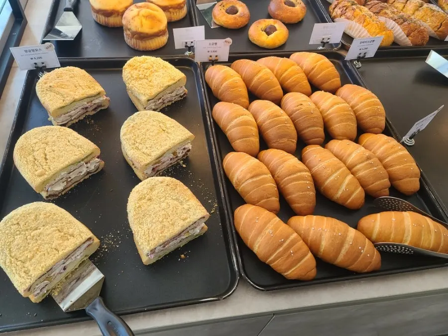 Assorted bread items at Café Sum's bakery counter