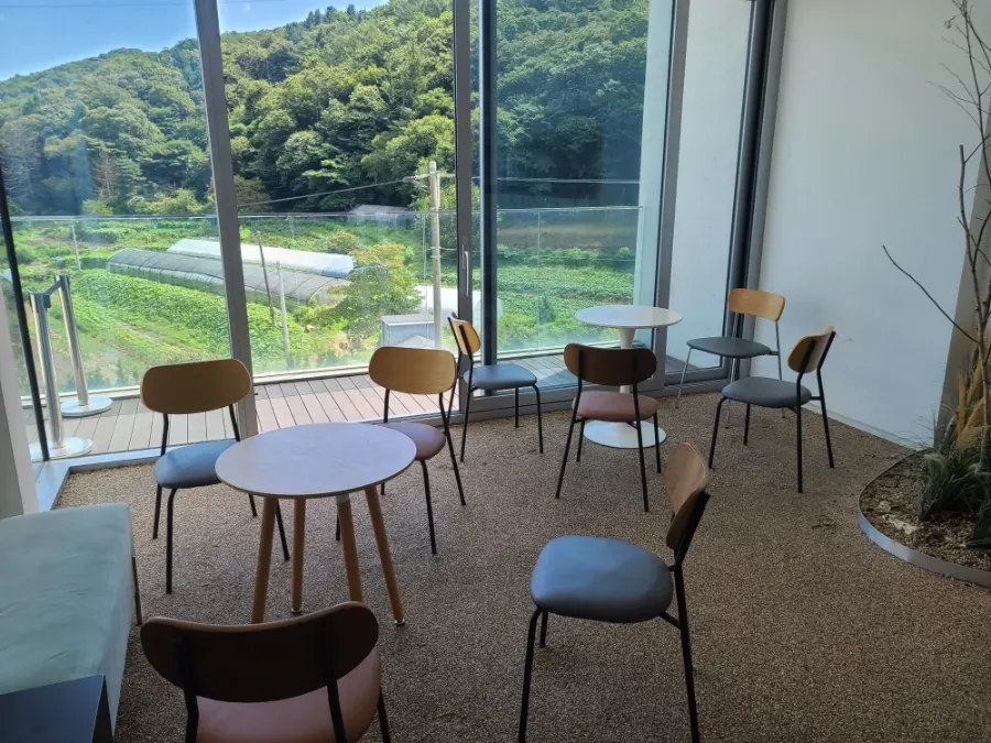 A cup of coffee at a seat with a view of the scenery outside