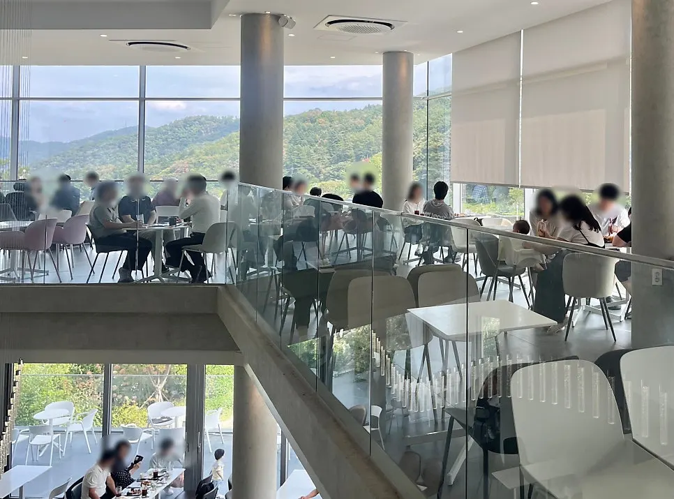 The high-ceilinged interior of the main building with floor-to-ceiling windows