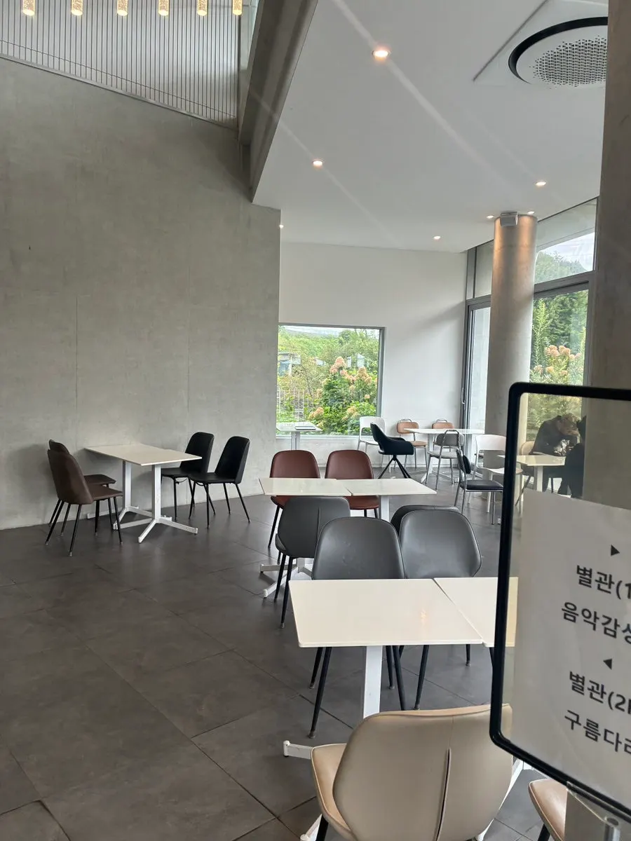 Table seating in front of the forest-view windows