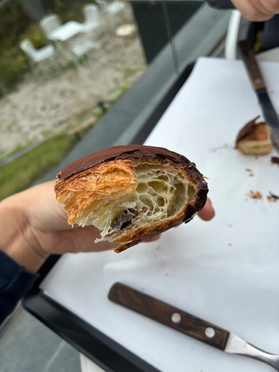 Cross-section of pain au chocolat topped with cocoa powder