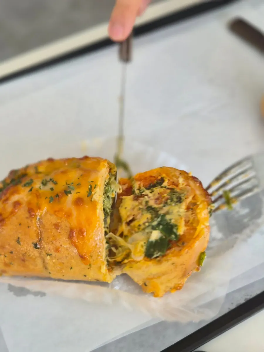 A cross-section of Sum's basil pizza bread cut in half