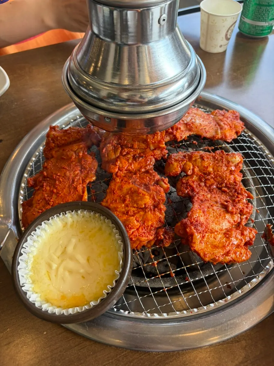 Menu board listing charcoal dakgalbi options at Anbanji