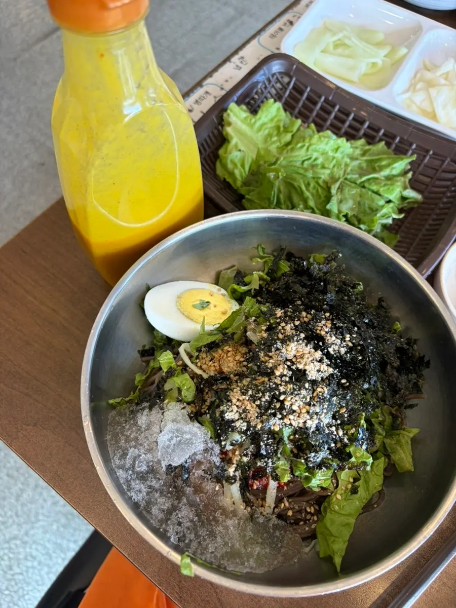 A piece of charcoal dakgalbi dipped in cheese fondue