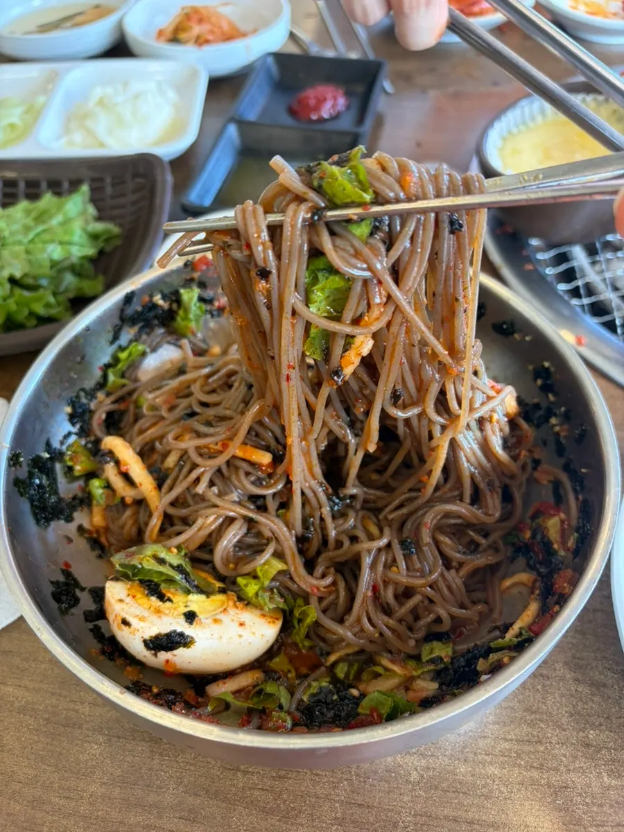 A chopstick-full of buckwheat mak guksu noodles