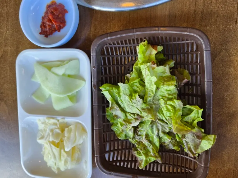 Table spread with lettuce wraps and side dishes