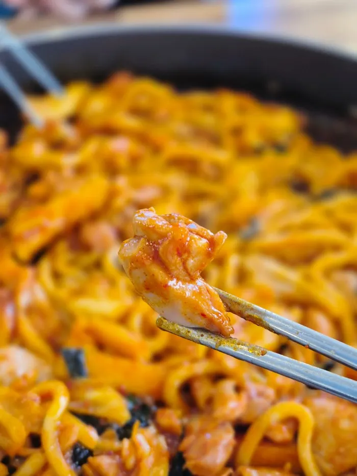 Picking up a piece of dakgalbi