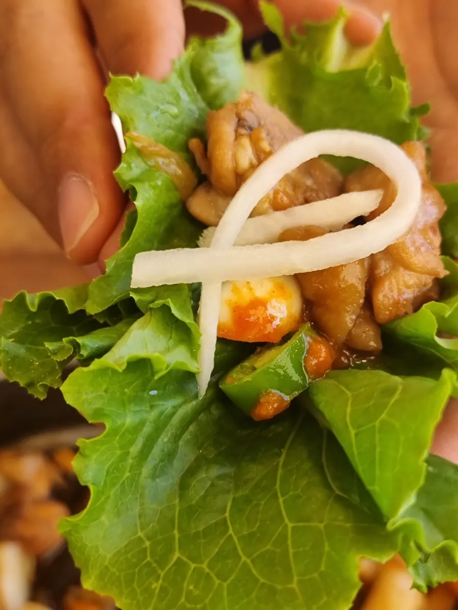 Lettuce wrap with chicken, shredded radish, and ssamjang