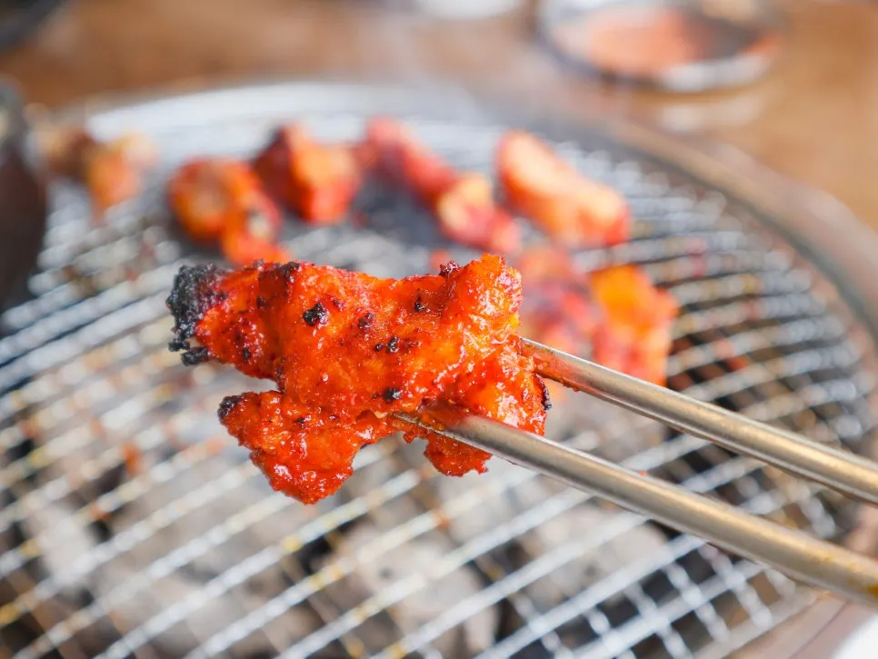 Marinated dakgalbi cooking as the sauce sizzles