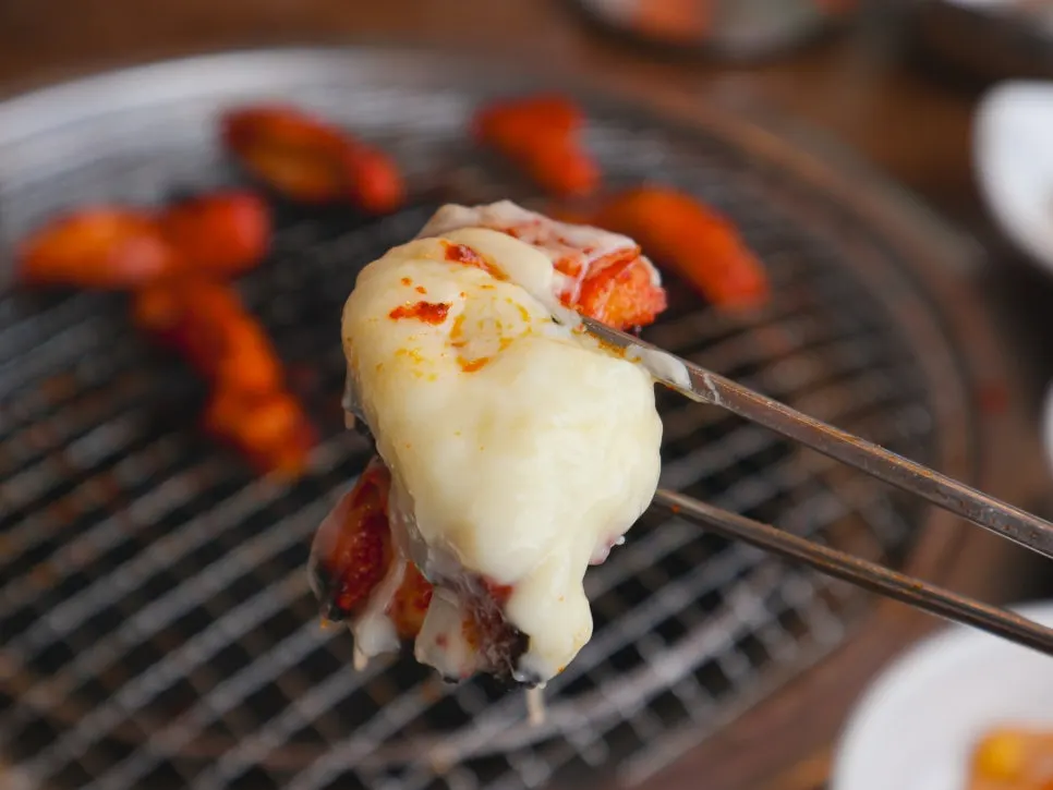 Cheese fondue served alongside the dakgalbi