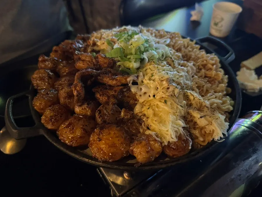 Mapdalgu hot plate topped with cheese and ramen noodles