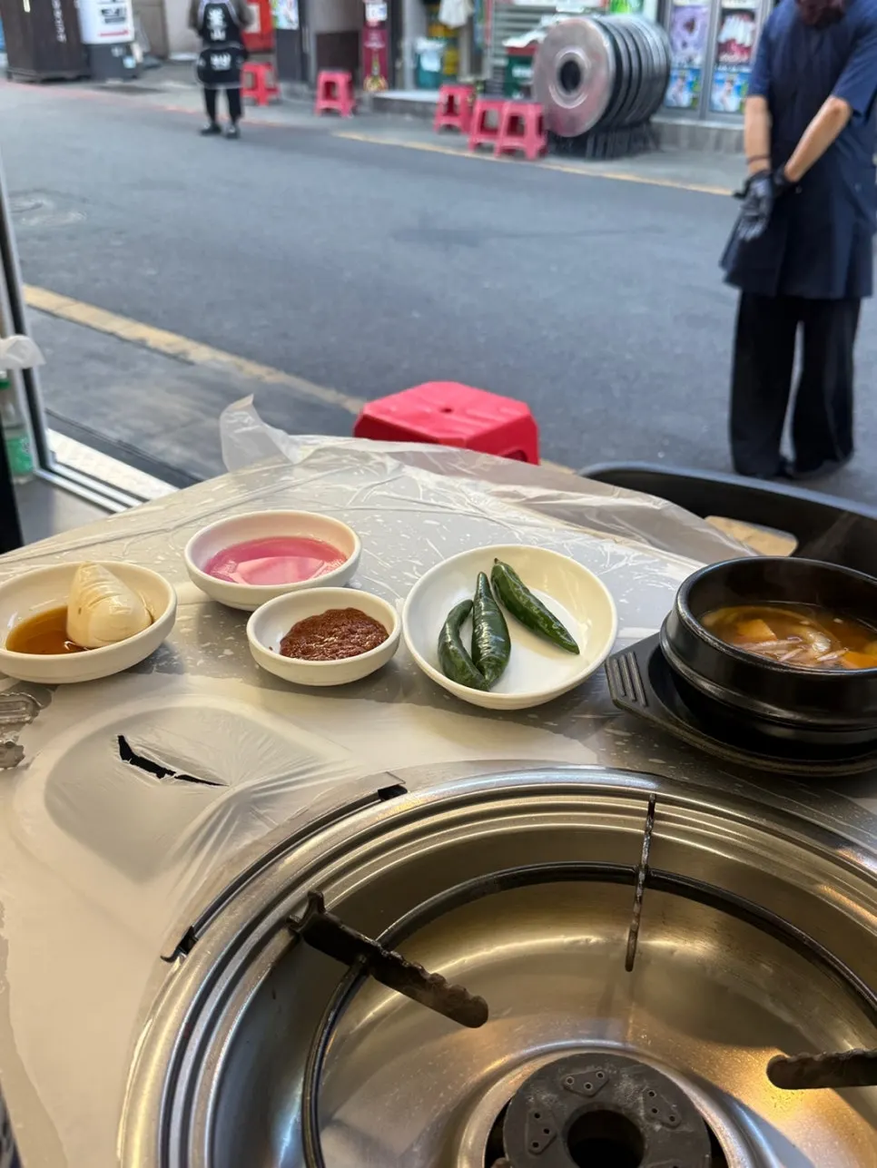 Basic table setting with salad, fresh kimchi, tofu, and pickled radish