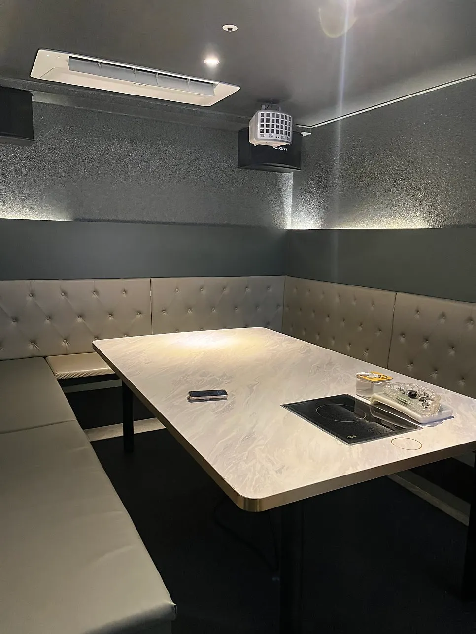 Spacious, clean interior of a karaoke bar room