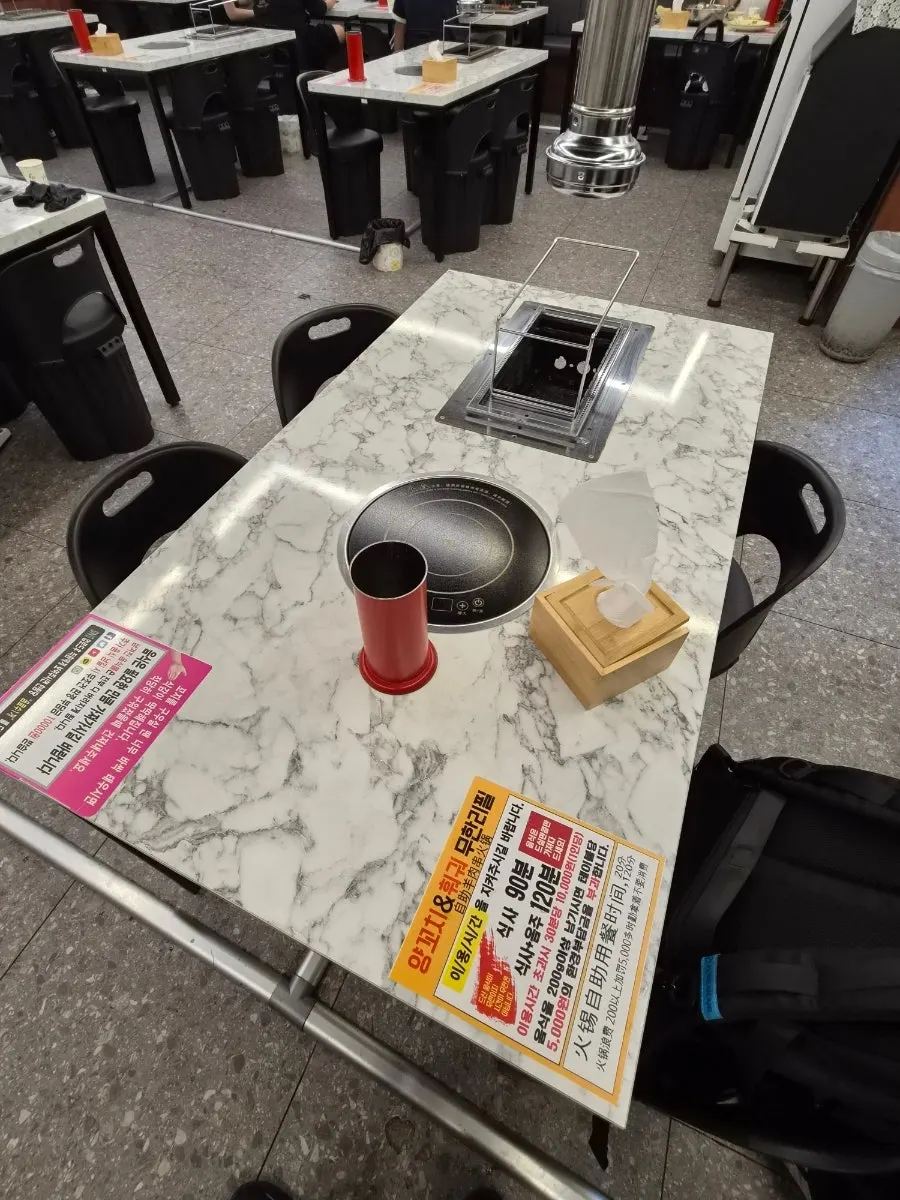 Table setup with a hotpot burner and lamb skewer grill