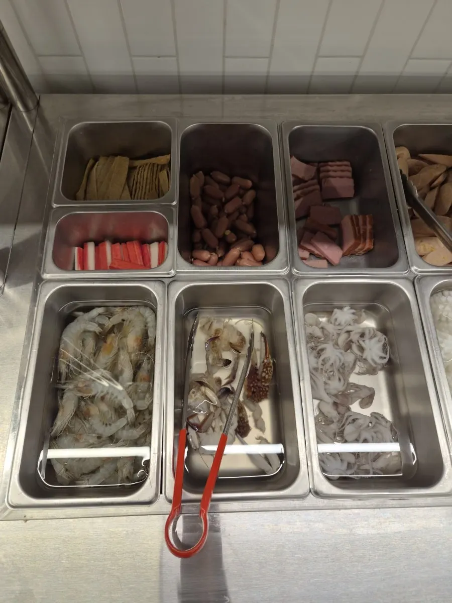 Hotpot self-bar displaying seafood and ham