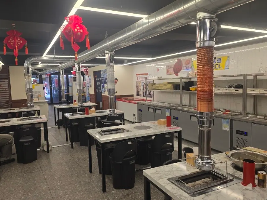 Interior table with a burner and ventilation fixture