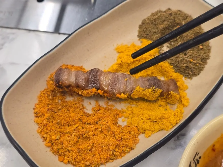 Seasoned lamb skewers being grilled