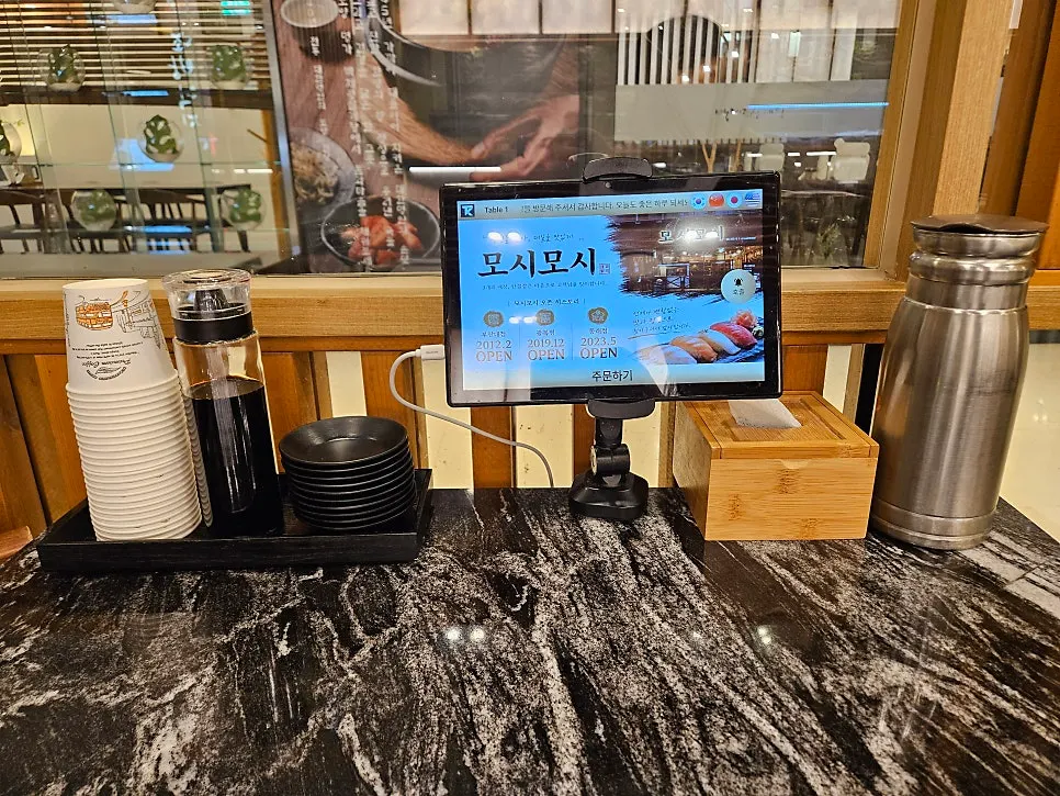 Interior of Moshi Moshi Sushi with 4-person tables