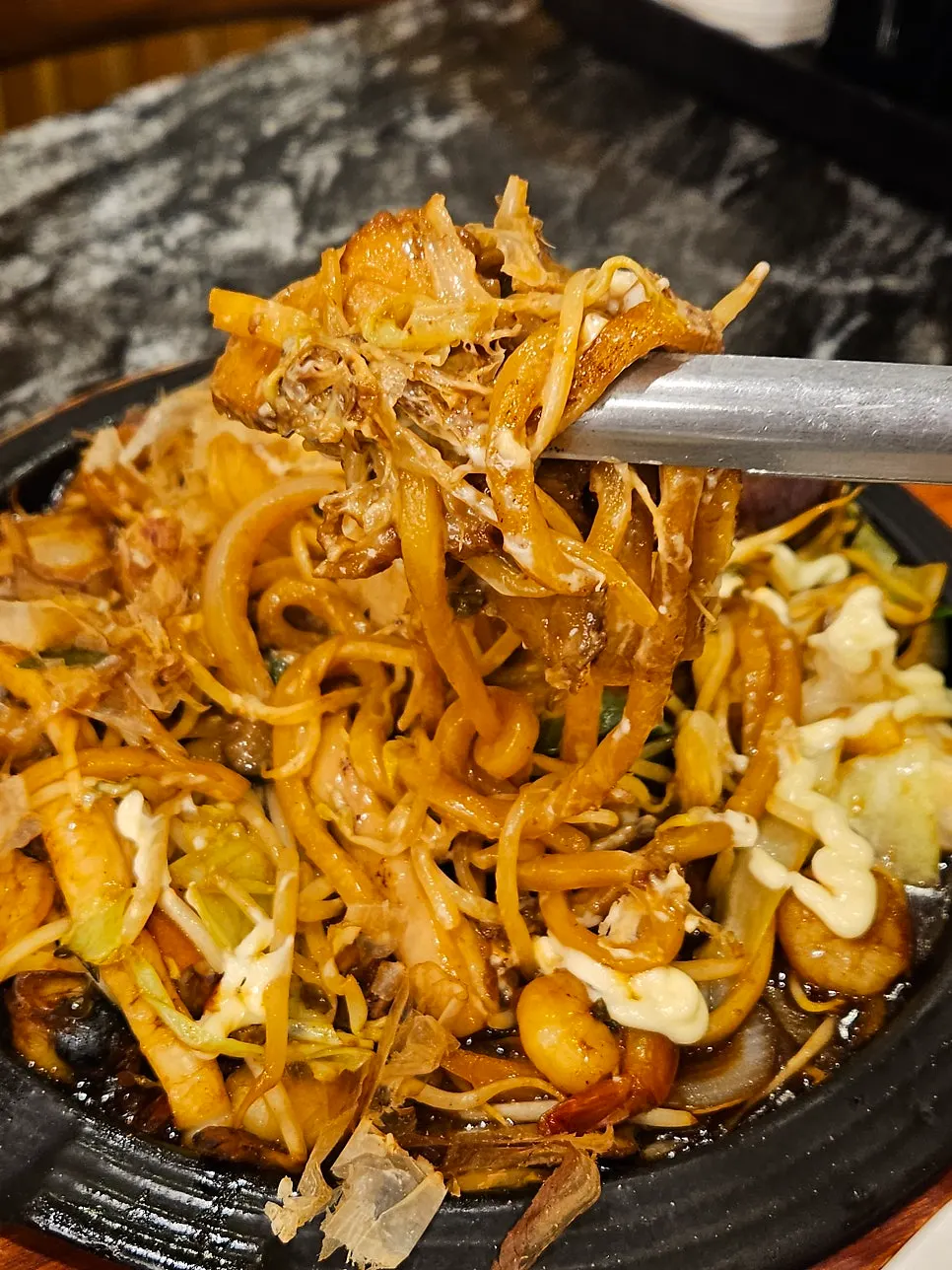 Close-up of yaki udon topped with bonito flakes