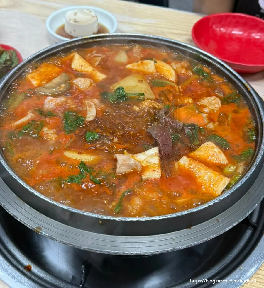 A ladleful of broth scooped from the gopchang hotpot