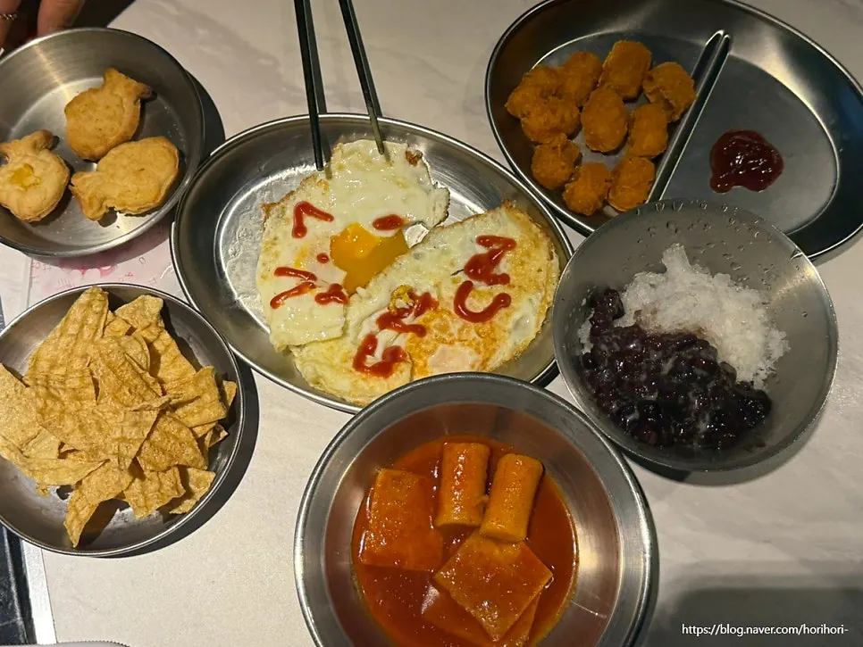 Fried egg, popcorn chicken, and tteokbokki basic side dishes