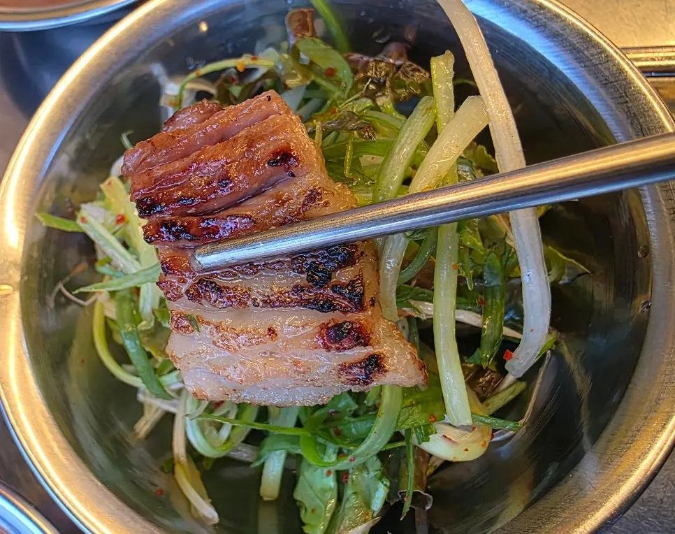 A piece of pork rib dipped in sauce