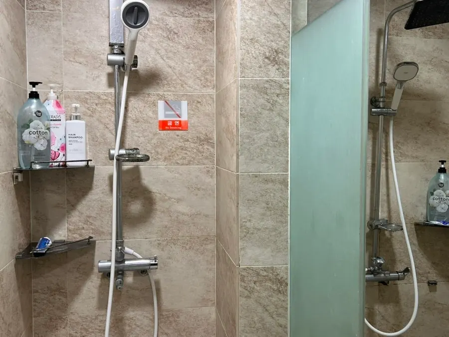 Shelf of amenities including disposable toothbrushes and shampoo