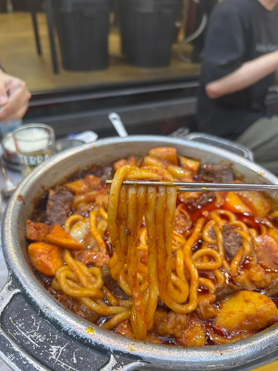 A drink alongside gopchang at the street stall