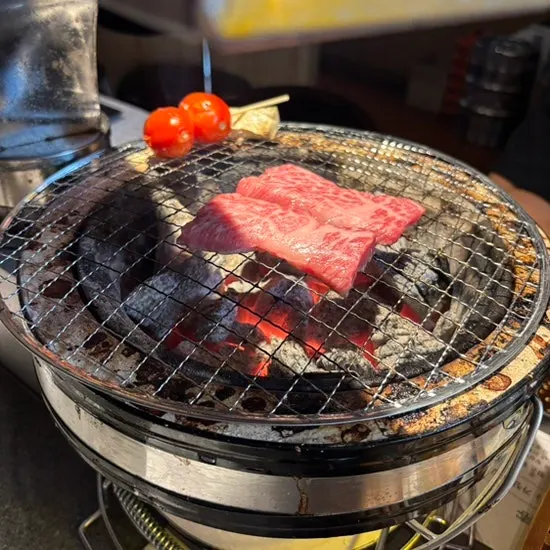 Thinly sliced beef tongue on the charcoal grill