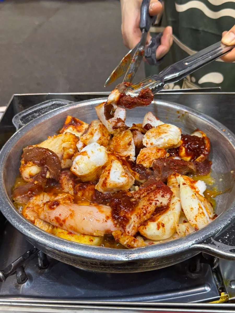 Staff grilling the seasoned tripe for us