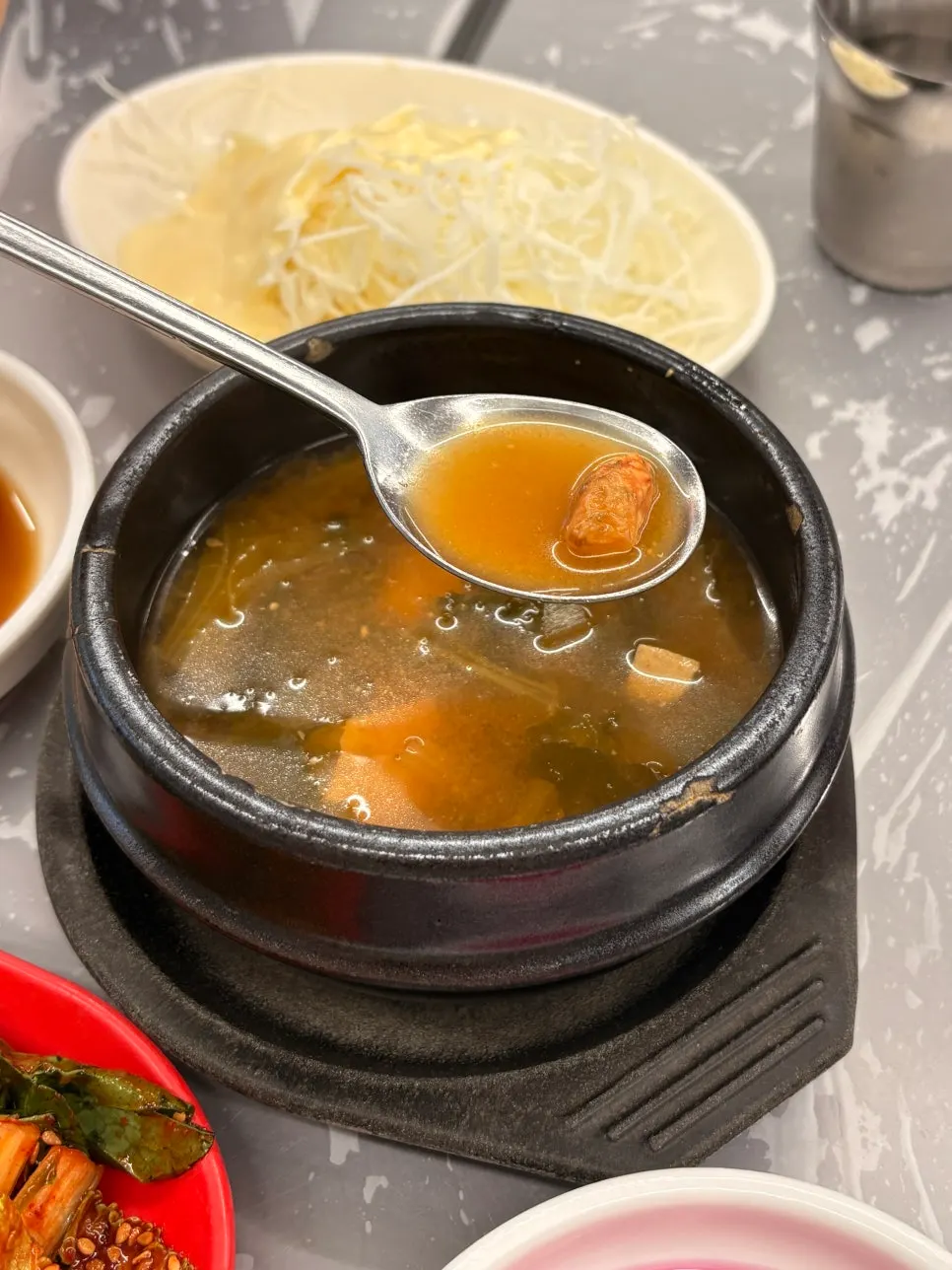 Basic side dishes of sundubu, geotjeori, and salad