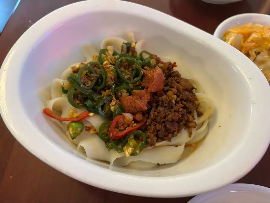 The ordered knife-cut noodles and dim sum spread