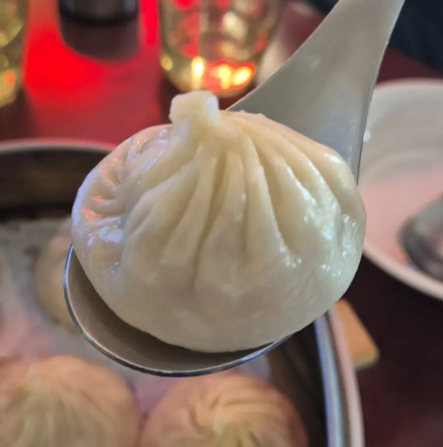 Plate of dim sum served with shredded ginger